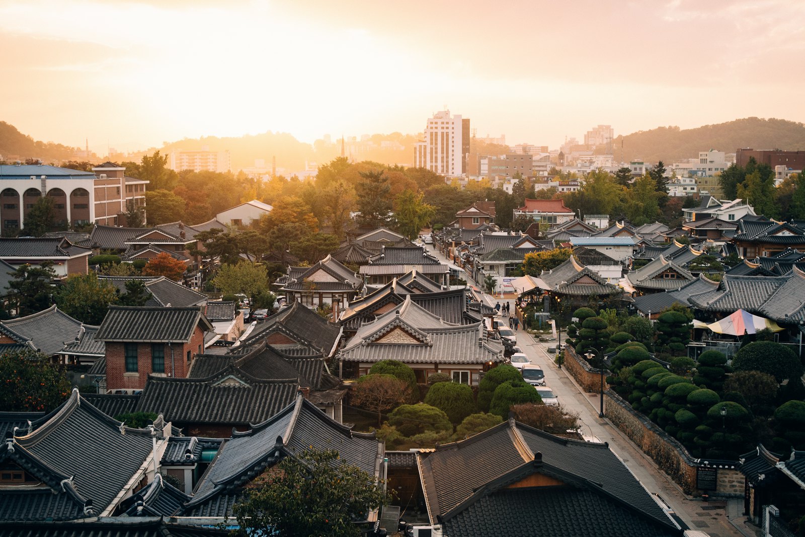 A traditional Korean hanok village at golden hour